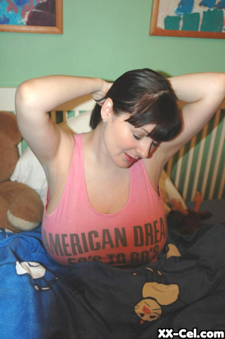 Dark haired amateur Lorna Morgan shows her humongous boobies and stretches her ass