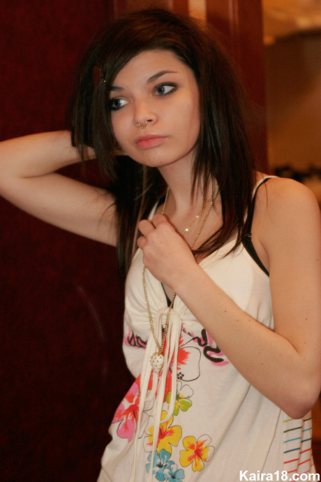 Tiny teen Kaira 18 scrunches up her face during a non undressed shoot in a bathroom