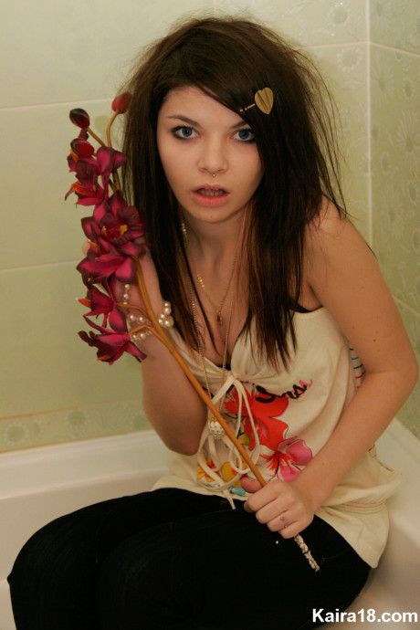 Tiny teen Kaira 18 scrunches up her face during a non undressed shoot in a bathroom