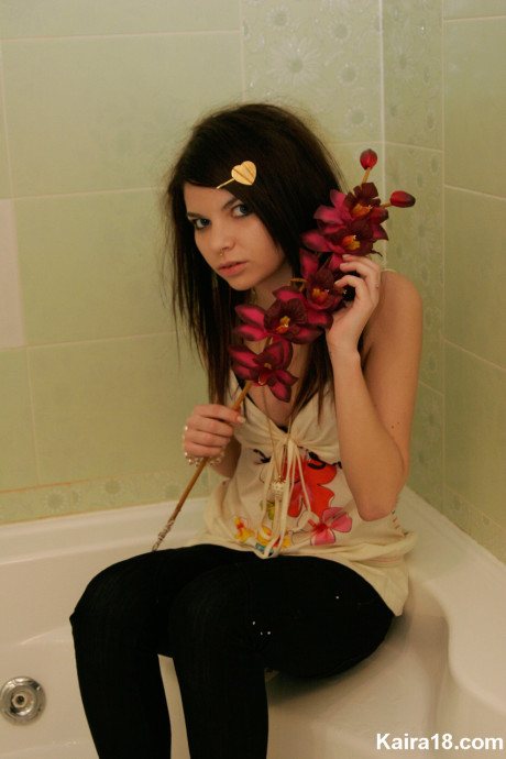 Tiny teen Kaira 18 scrunches up her face during a non undressed shoot in a bathroom