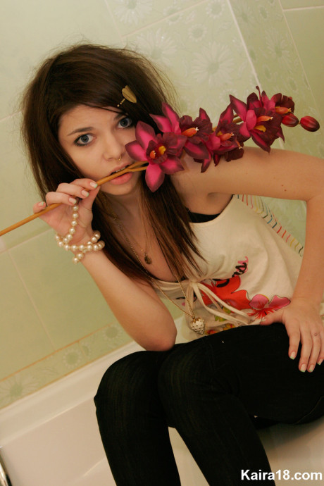 Tiny teen Kaira 18 scrunches up her face during a non undressed shoot in a bathroom