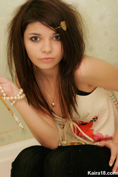 Tiny teen Kaira 18 scrunches up her face during a non undressed shoot in a bathroom