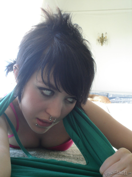 Short-haired punk bitch chick with pierced nose, lip, navel in her own photos
