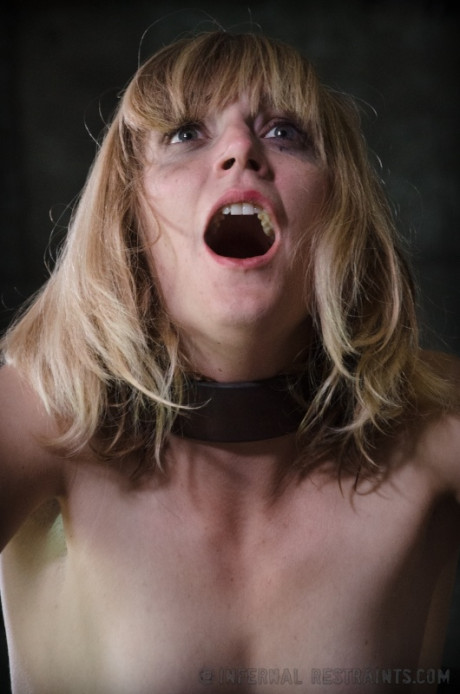 Clothed female Mona Wales finds herself being restrained in a cage