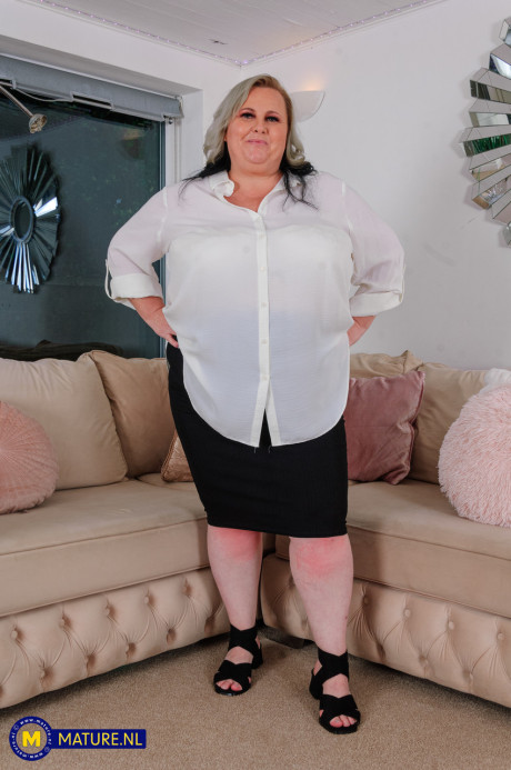 Mature SSBBW licks a nipple before taking a sex toy to her vagina