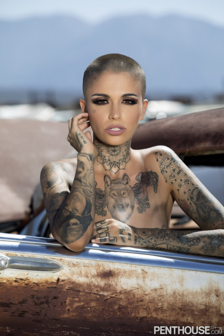 Bald inked babe Leigh Raven flaunts her small boobies and poses naked outdoors