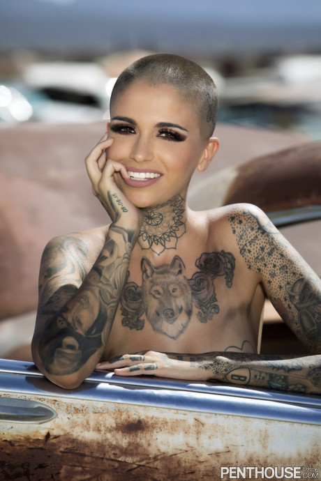 Bald inked babe Leigh Raven flaunts her small boobies and poses naked outdoors
