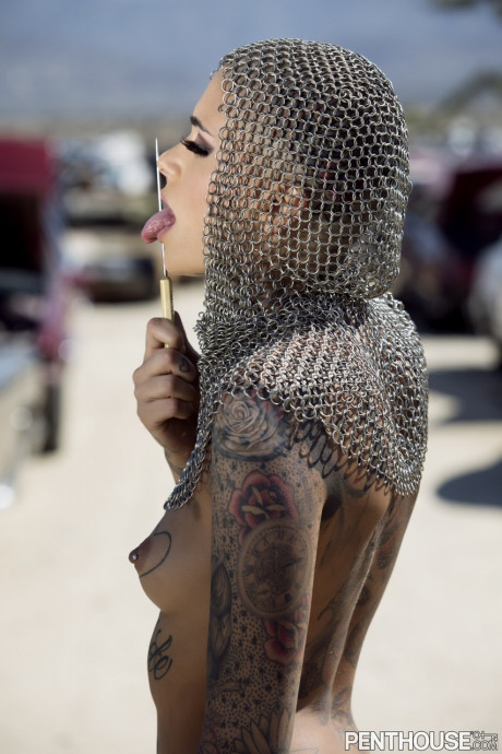 Bald inked babe Leigh Raven flaunts her small boobies and poses naked outdoors