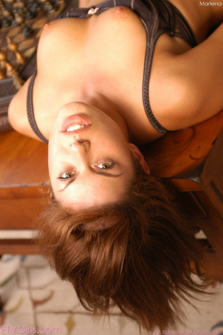 Dark-haired babe Marlena loses her panties and rides herself with a heel