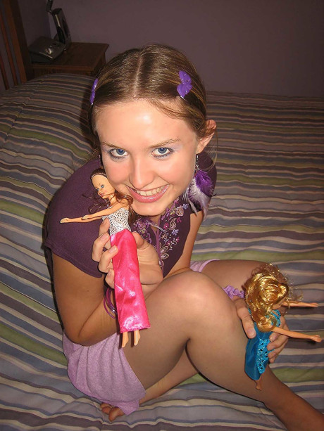 Sweet brunette Kitty strips and toys herself after playing with Barbies
