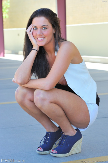 Green-eyed beauty Harper strips at the parking lot and poses undressed