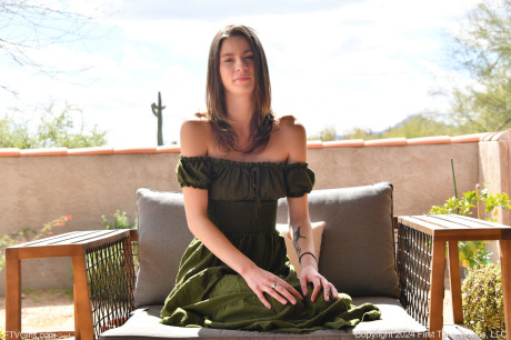 Pretty babe Lily plays with her shaved pussy with a dildo while undressed outdoors