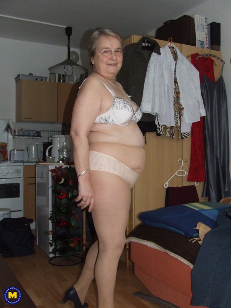 Meaty European old lady Sybille stripping off her clothes and skin tone tights