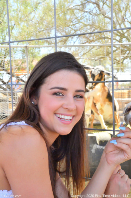 Smiley amateur babe Kylie poses in her denim shorts & white shirt at the zoo