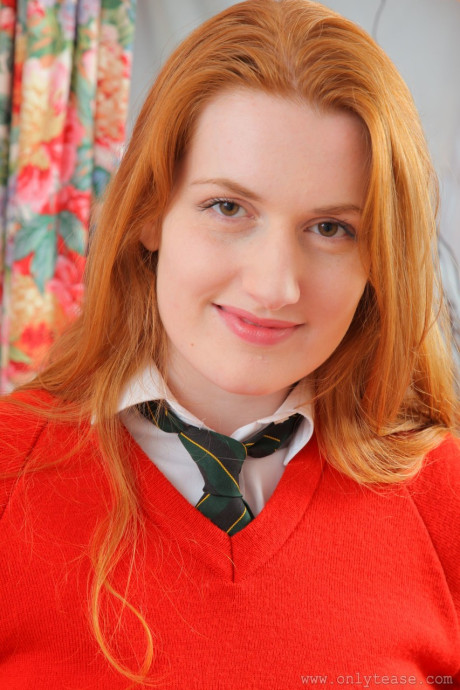 Redhead college babe Vasilisa exposes her natural juggs and poses in panties