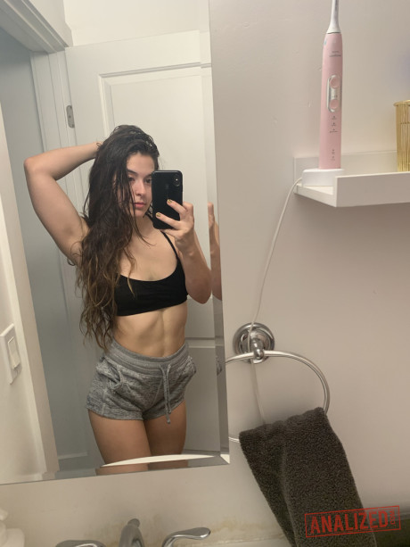 Amateur model holds her raw butt during a series of naked selfies