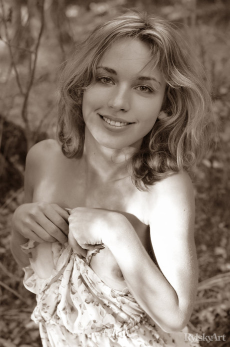 Young young blondy Natalia B takes off her dress to go totally nude in the woods