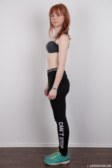 Charming red hair amateur uncovers her barely budding boobies as she gets undressed