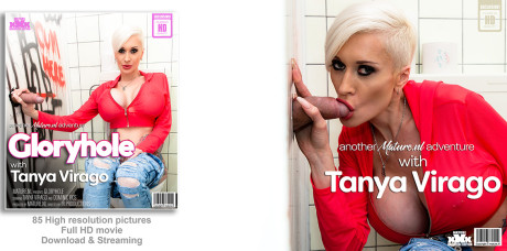 Older blondy Tanya Virago gives a blowjob in a bathroom gloryhole