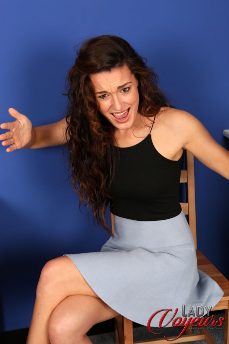 Cute babe Carla James flashes her orange lingerie while sitting on a rocker