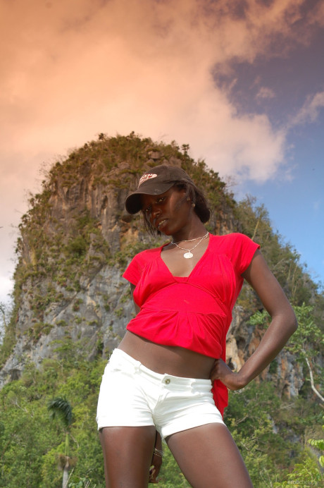 Black Maria L removes her shorts & red shirt & teases with her ass outdoors