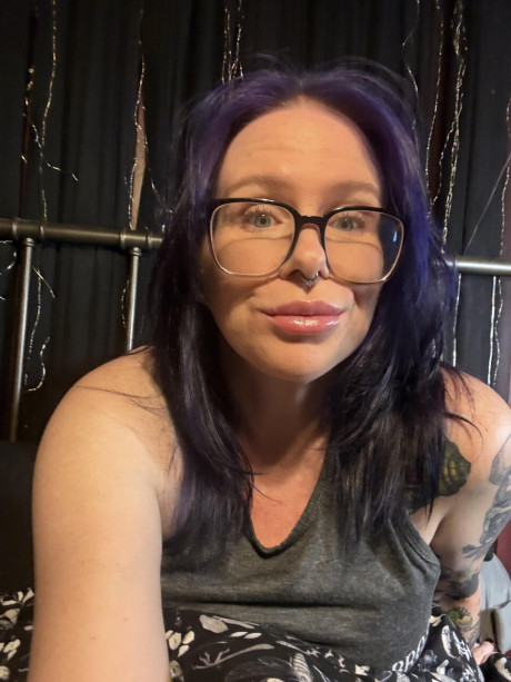 Tattooed amateur with purple hair and glasses takes selfies in the nude