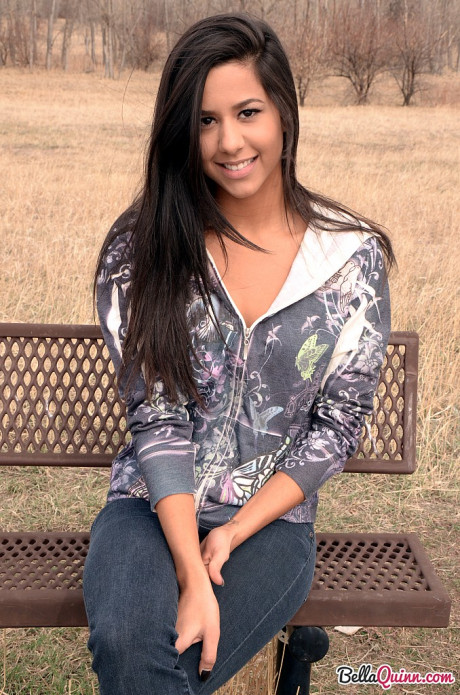 Amateur model Bella Quinn exposes ebony bra on an outdoor bench