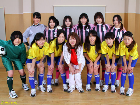 Chinese female football team watches as a teammate gets poked by the referees