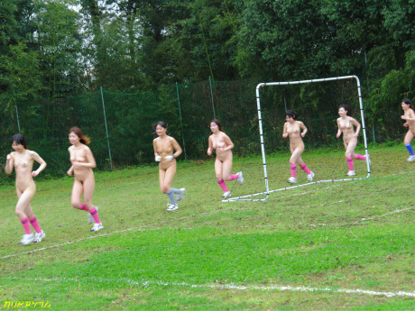 Chinese female football team watches as a teammate gets poked by the referees
