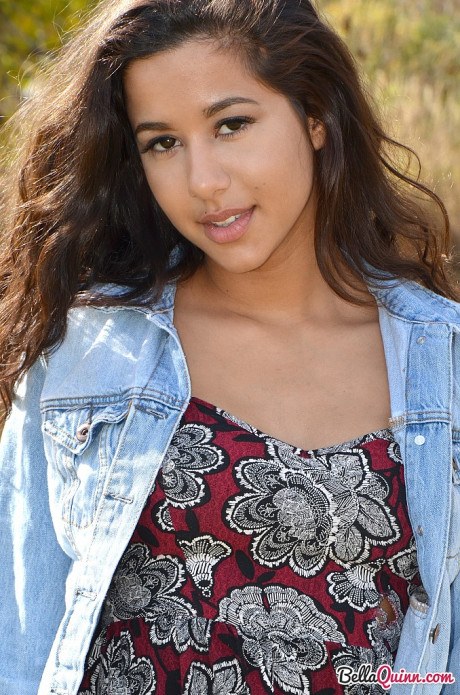 Latina first timer Bella Quinn covers up her exposed breasts in a field