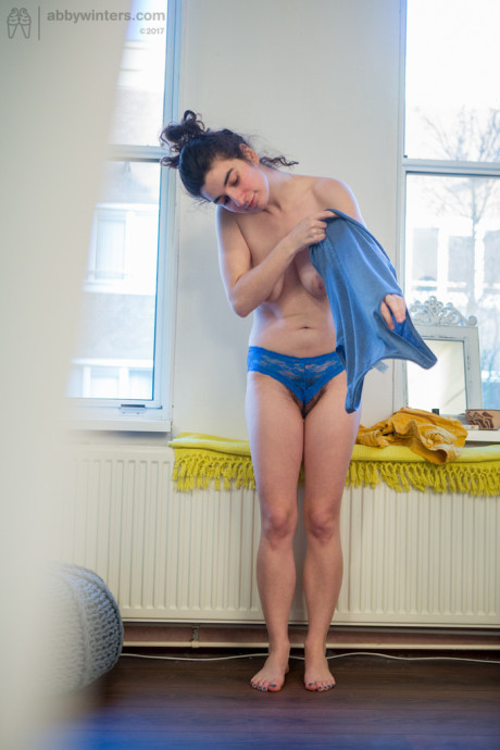 Undressed amateur Livia V is secretly filmed getting dressed by a hidden camera