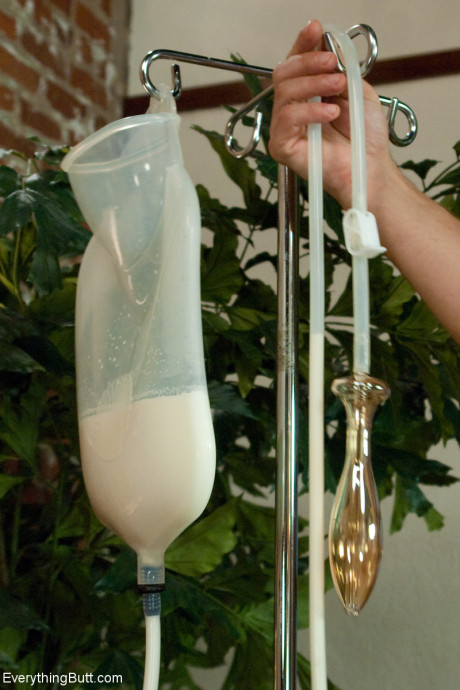 Curvaceous Beverly Hills taking a messy milk enema in a naughty BDSM scene