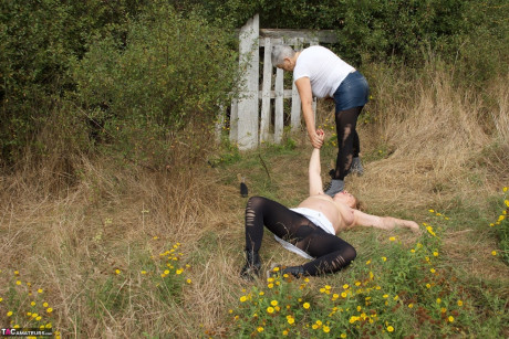 Mature British girl restrains busty old lady woman Speedy Bee while in the outdoors