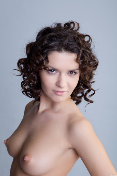 Curly-haired young Roza A undresses and flaunts her bushy holes in a solo