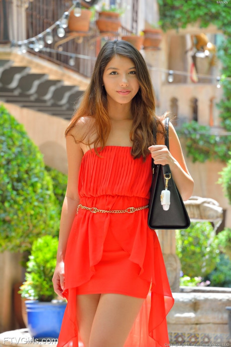 Natural beauty in a long red dress Melody flashing her bald cunt in public