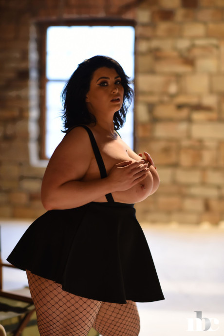 Chubby gorgeous whore woman Kiki lets out her giant juggs wearing a short skirt