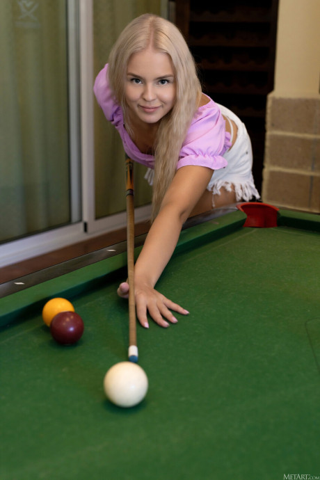 Gorgeous teenie babe Decima strips, sits on a pool table and spreads her pussy