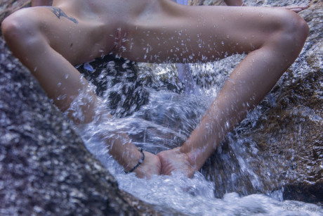 Gorgeous young Alisa M shows her nude body with her feet in the water