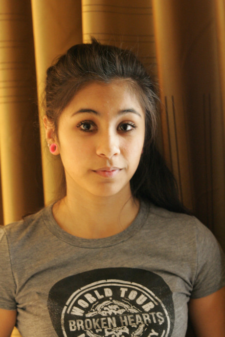 Beautiful Arab young model posing in her shirt and tight jeans at a casting