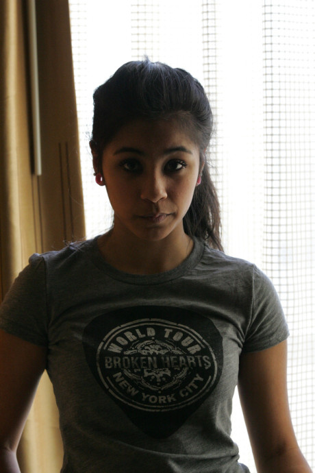 Beautiful Arab young model posing in her shirt and tight jeans at a casting