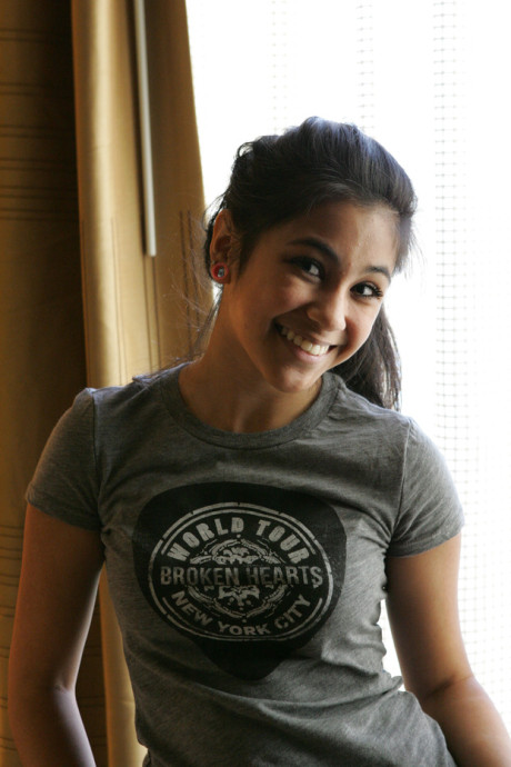 Beautiful Arab young model posing in her shirt and tight jeans at a casting