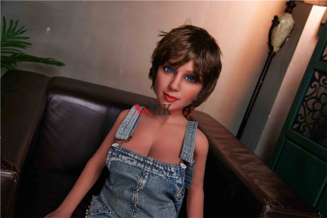 Skinny sex doll Sally shows off her nice bum and big breasts in the lamplight