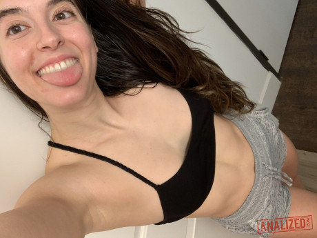 Brunette amateur takes selfies while getting nude in front of a mirror