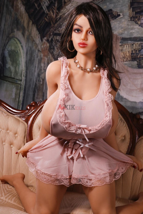 Stunning dark-haired sex doll shows off her great behind & her huge breasts