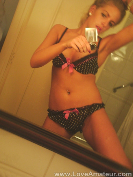Lovely British lady girlfriend woman Dani Divine takes selfies in a mirror while getting undressed