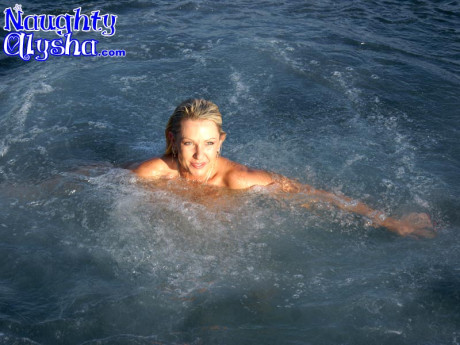 Busty blondie pops the cork on a bottle of champagne while it's in her pussy