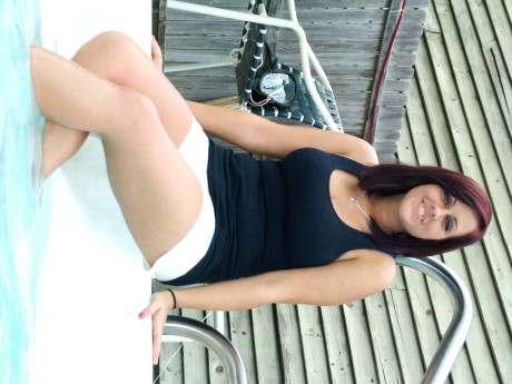 Dark-haired amateur teen Roxy goes unclothed poolside & shows her big titties