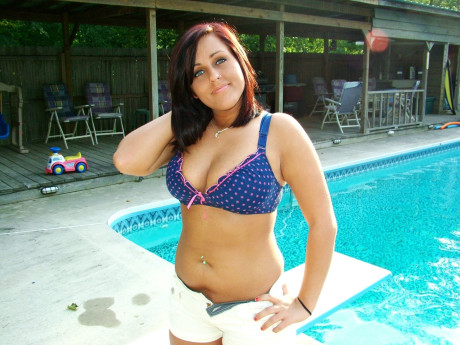 Dark-haired amateur teen Roxy goes unclothed poolside & shows her big titties