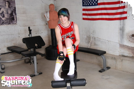 Amateur chick girl lady Sabrina Squirts takes a giant pee on a weightlifting bench in socks