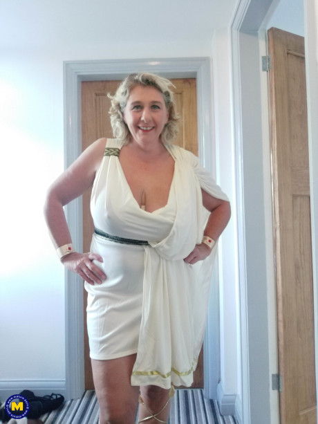 Blonde cougar with huge boobs Camilla C shows her bum in a solo